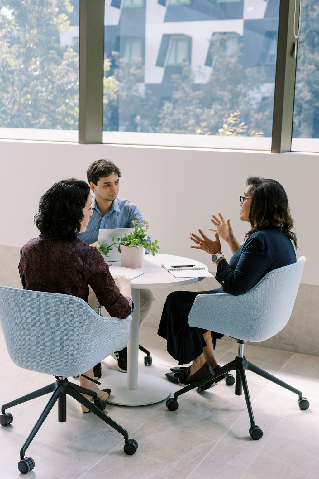 Team members meeting around a table to discuss culture